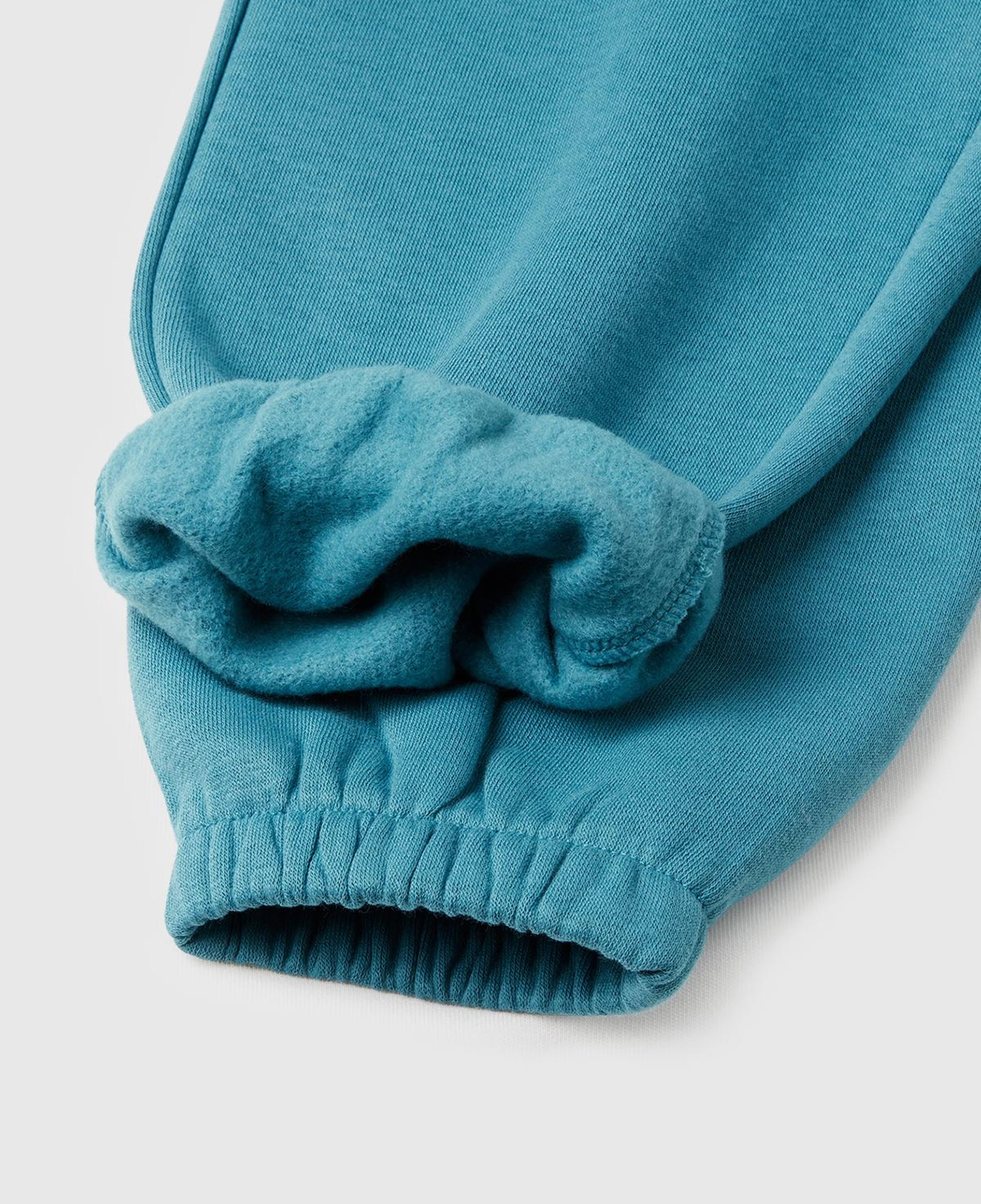 Kız Çocuk Petrol Mavisi Arkası Logo Detaylı Beli Paçası Lastikli Büzgü İpli Şardonlu Eşofman Altı